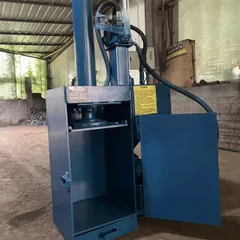 Professional paint bucket flattening machine. Small, vertical, fully steel-framed hydraulic baling machine