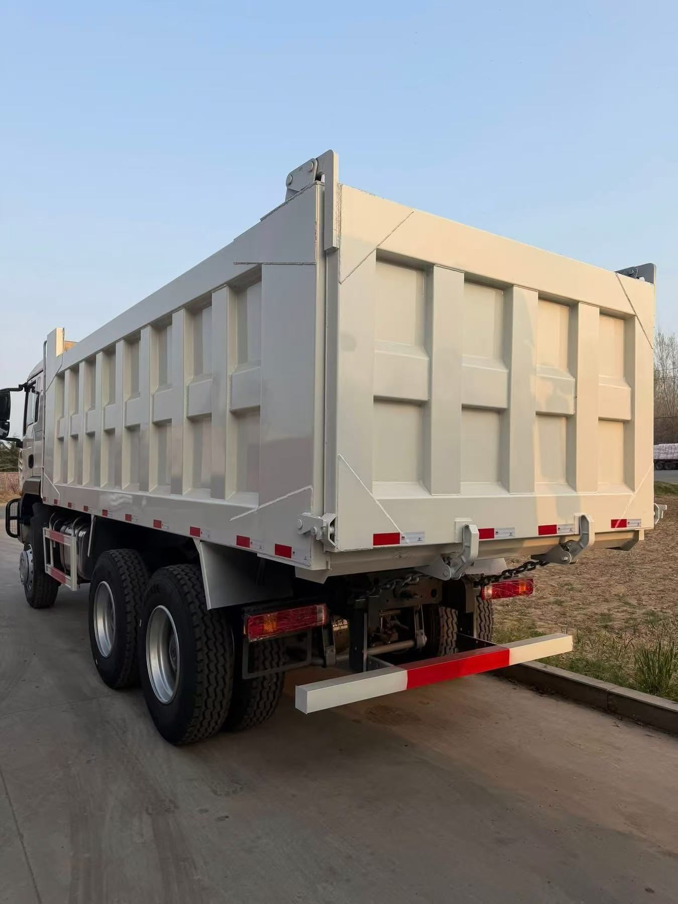 Drive Configuration: 6×4 (single front steering axle + double rear drive axles, 10 tires in total), the mainstream configuration for heavy-duty engineering vehicles Scenario: The vehicles in the picture are parked in a large heavy-duty truck warehouse pla