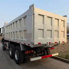 Drive Configuration: 6×4 (single front steering axle + double rear drive axles, 10 tires in total), the mainstream configuration for heavy-duty engineering vehicles Scenario: The vehicles in the picture are parked in a large heavy-duty truck warehouse pla