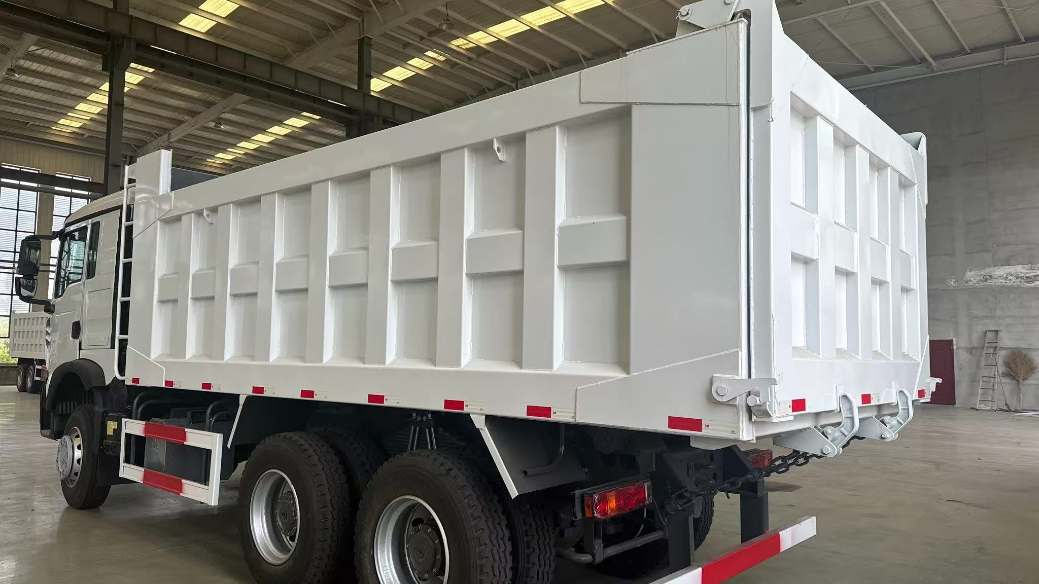 Drive Configuration: 6×4 (single front steering axle + double rear drive axles, 10 tires in total), the mainstream configuration for heavy-duty engineering vehicles Scenario: The vehicles in the picture are parked in a large heavy-duty truck warehouse pla